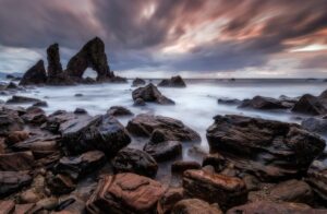 Rocce, archi e mare: lettura calma tra textures e luci calde