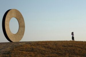 Equilibrio tra figura umana e cerchio: quiete e geometria nel paesaggio
